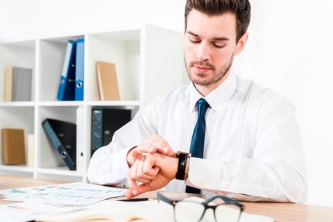 young-businessman-workplace-watching-time-wrist-watch